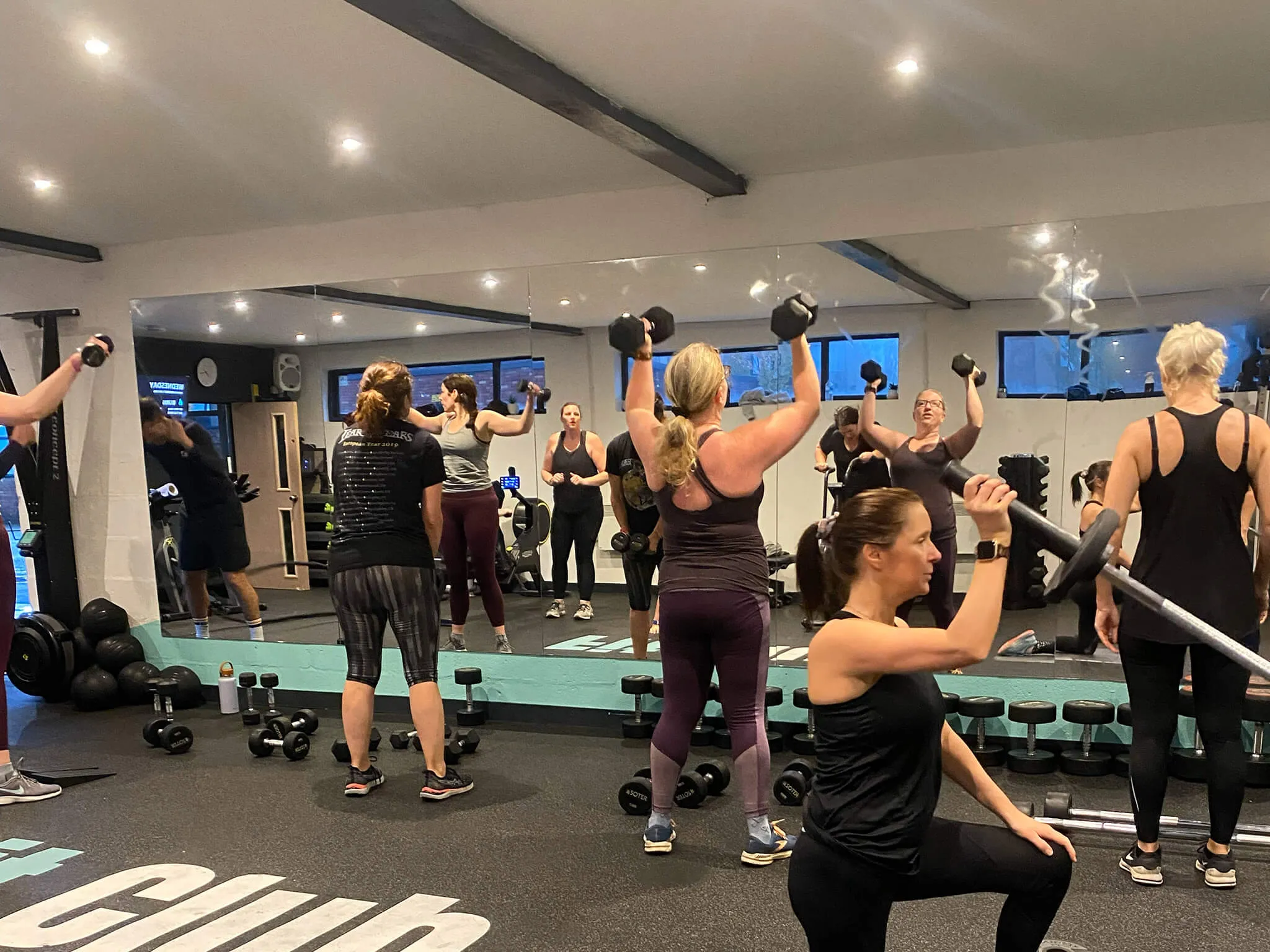 Group workout session with participants exercising indoors