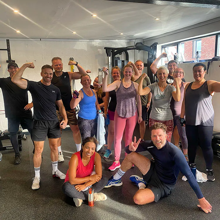 Gym members focused on strength and conditioning exercises
